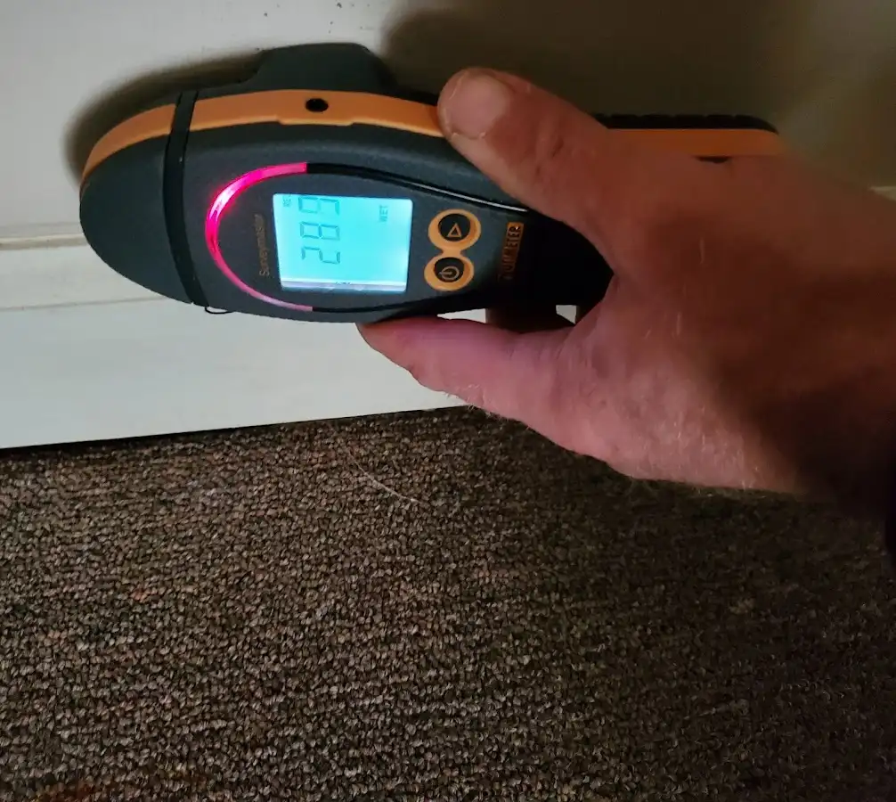 Moisture detection at baseboard during Storm Damage Restoration in Maple Shade